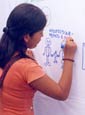 young girl writes on a graffiti  message board in Lima, Peru